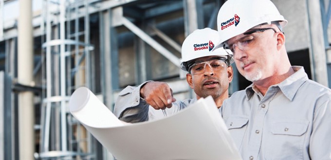 Boiler technicians looking at plans